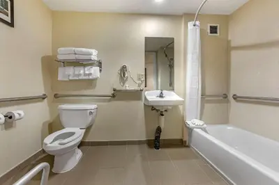 a bathroom with a toilet and a sink and a tub at Comfort Suites Visalia - Convention Center in Visalia