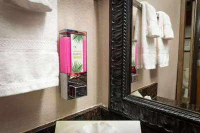 a mirror in a bathroom with a sink and towels at Quality Inn Bishop near Mammoth in Bishop