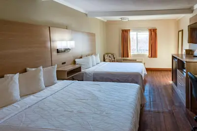 a hotel room with two beds and a television at Quality Inn Bishop near Mammoth in Bishop