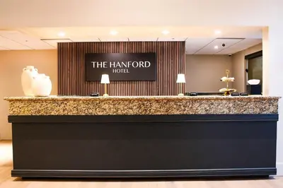 a hotel lobby with a reception counter with a harford hotel sign at The Hanford Hotel, an Ascend Collection Hotel in Hanford