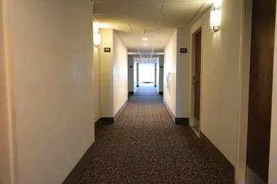 a hallway of an office building with a long corridor at The Hanford Hotel, an Ascend Collection Hotel in Hanford