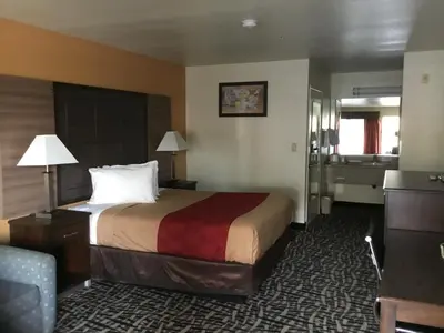 a hotel room with a bed and a couch at Executive Inn westley,CA in Westley