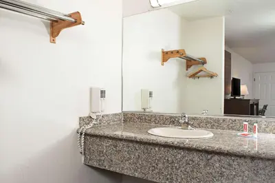 a bathroom with a sink and a mirror at Executive Inn westley,CA in Westley