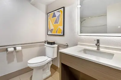 a bathroom with a white toilet and a sink at Comfort Inn & Suites Sacramento - University Area in Sacramento
