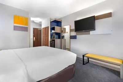 a hotel room with a bed and a tv at Comfort Inn & Suites Sacramento - University Area in Sacramento