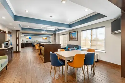 an office lobby with a table and chairs at Comfort Inn & Suites Sacramento - University Area in Sacramento