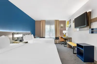 a hotel room with two beds and a desk at Comfort Inn & Suites Sacramento - University Area in Sacramento