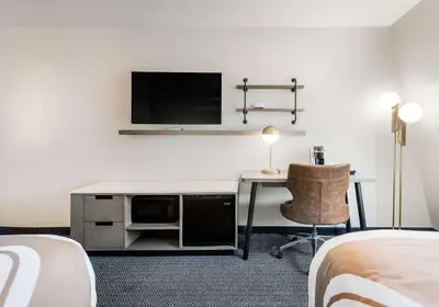 a hotel room with a desk and a flat screen tv at Quality Inn South Lake Tahoe in South Lake Tahoe