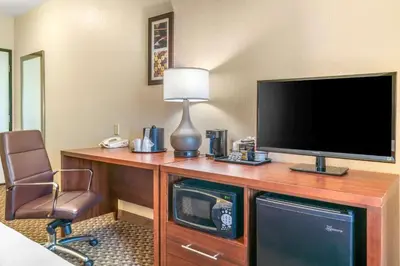 a room with a desk with a television and a chair at Comfort Inn & Suites Galt - Lodi North in Galt