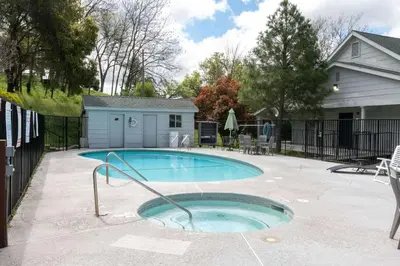 a swimming pool in a yard with a fence at Quality Inn Yosemite Valley Gateway in Mariposa