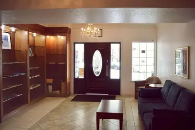 a living room with a black door and a couch at Quality Inn Yosemite Valley Gateway in Mariposa
