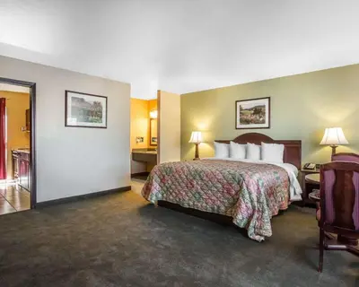 a hotel room with a large bed and a room at Quality Inn & Suites Cameron Park Shingle Springs in Cameron Park