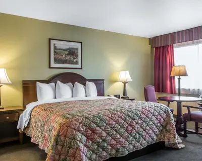 a hotel room with a large bed and a window at Quality Inn & Suites Cameron Park Shingle Springs in Cameron Park