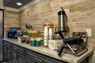 a kitchen with a counter top with a mixer and food at Quality Inn & Suites South San Jose - Morgan Hill in Morgan Hill