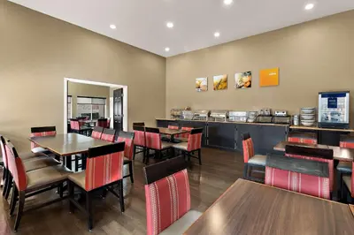 a restaurant with tables and chairs and a counter at Comfort Inn & Suites Sequoia Kings Canyon in Three Rivers