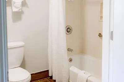 a bathroom with a toilet and a bath tub at Quality Inn & Suites Lathrop in Lathrop