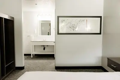 a white bathroom with a sink and a mirror at Quality Inn & Suites Lathrop in Lathrop