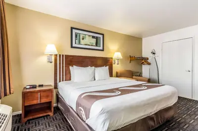 a bedroom with a large bed in a hotel room at Quality Inn Fresno Near University in Fresno