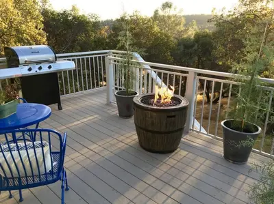 a patio with a fire pit on a deck at Papillon Cellars - The Loft in Mariposa