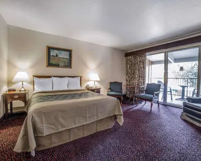a hotel room with a bed and a balcony at Econo Lodge Near Reno-Sparks Convention Center in Reno