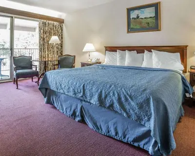 a hotel room with a bed and a balcony at Econo Lodge Near Reno-Sparks Convention Center in Reno