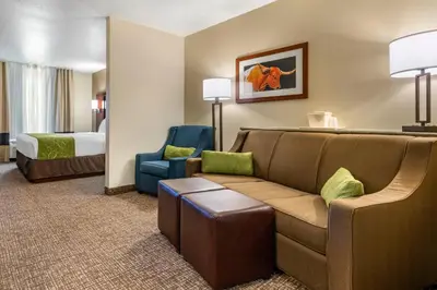 a hotel room with a couch and a bed at Comfort Suites Fernley in Fernley