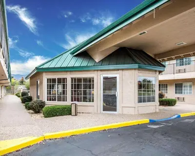 a building with a green roof on a street at Quality Inn & Suites Minden in Minden