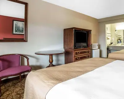 a hotel room with a bed and a tv at Quality Inn & Suites Minden in Minden