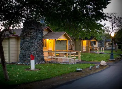 a house with a cabin with a stone chimney at Wonder Valley Ranch Resort in Pine Flat Lake
