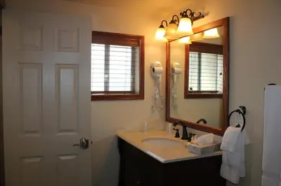 a bathroom with a sink and a mirror at Wonder Valley Ranch Resort in Pine Flat Lake