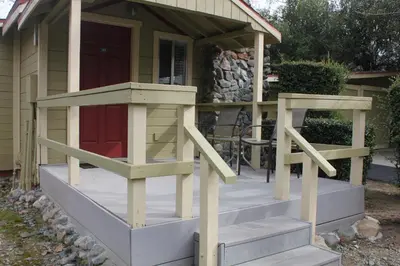 a porch with a dog house on it at Wonder Valley Ranch Resort in Pine Flat Lake