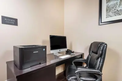 a desk with a computer monitor and a chair at Comfort Inn Tonopah in Tonopah