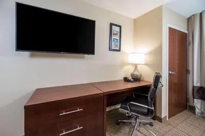 a desk with a television and a chair in a hotel room at Comfort Inn Tonopah in Tonopah