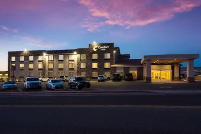 a hotel with cars parked in a parking lot at Comfort Inn Tonopah in Tonopah
