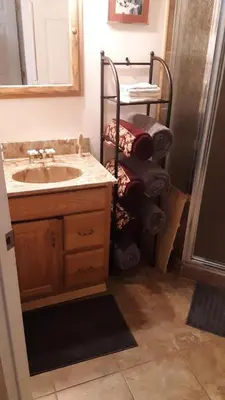 a bathroom with a sink and a towel rack at Winterfell Inn - No Xtra Fees, Dogs OK, King & Queen Suites in Arnold