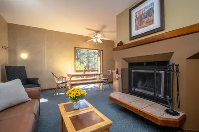 a living room with a couch and a fireplace at Olympic Village Inn Olympic Valley in Olympic Valley
