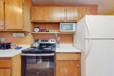 a small kitchen with a stove and a refrigerator at Take me back to Talbot in South Lake Tahoe
