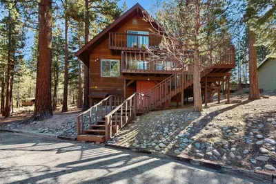 a cabin in the woods with a staircase leading up to it at Take me back to Talbot in South Lake Tahoe