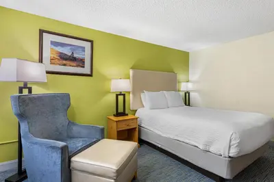 a hotel room with a bed and a chair at Best Western Hi-Desert Inn in Tonopah
