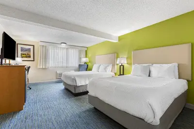 a hotel room with two beds and a television at Best Western Hi-Desert Inn in Tonopah