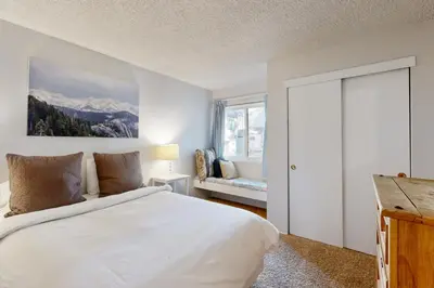 a white bedroom with a bed and a window at 2 Bed 2 Bath Apartment in Carnelian Bay in Carnelian Bay