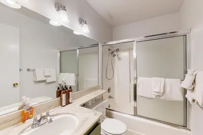 a white bathroom with a sink and a shower at 2 Bed 2 Bath Apartment in Carnelian Bay in Carnelian Bay