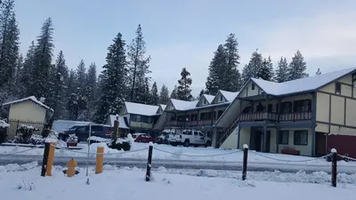 a group of houses in the snow with a fire hydrant at Wildwood Inn in Twain Harte