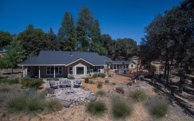 a house with a fire pit in the yard at Red Tail Ranch in Groveland