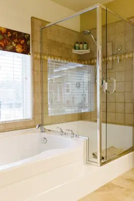 a bathroom with a tub and a glass shower at Red Tail Ranch in Groveland