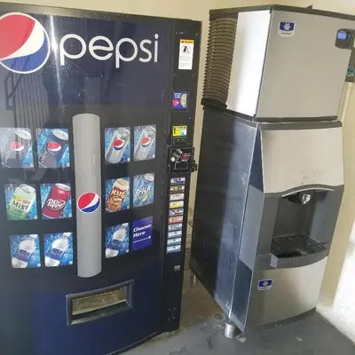 a pepsi vending machine next to a soda machine at SureStay Hotel by Best Western Hollister in Hollister