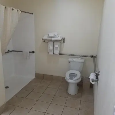 a bathroom with a toilet and a sink and a shower at SureStay Hotel by Best Western Hollister in Hollister