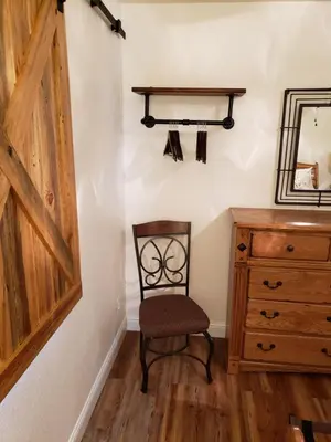 a chair in a room with a dresser and a mirror at Yosemite Foothill Retreat - Private Guest Suite #3 in Coarsegold