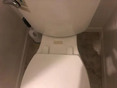 a close up of a white toilet in a bathroom at WHOLE Family - WholeVille in Sacramento