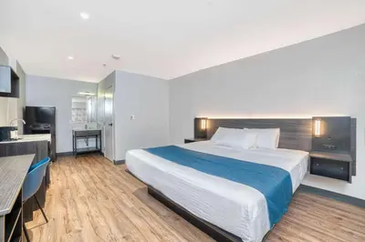 a hotel room with a large bed and a kitchen at Studio 6 Suites Stockton, CA Waterfront in Stockton